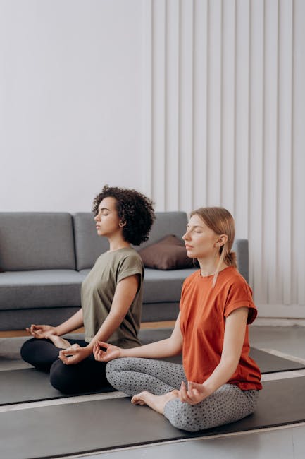 A person deeply focused while doing a balancing yoga pose in their living room